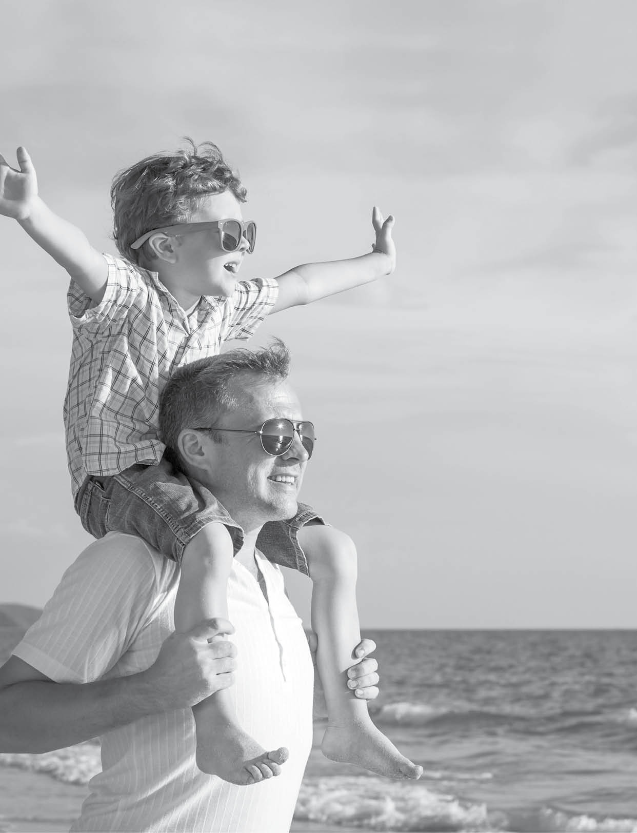 Father and son playing on the beach at the day time  Concept of friendly family 