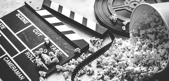 watching movie with popcorn on gray background close up