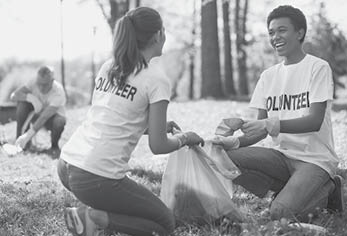 Green volunteering  Optimistic two volunteers holding garbage bag and communicating