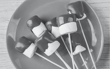 Chocolate fondue with marshmallow on table