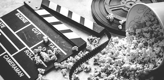 watching movie with popcorn on gray background close up