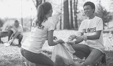 Green volunteering  Optimistic two volunteers holding garbage bag and communicating