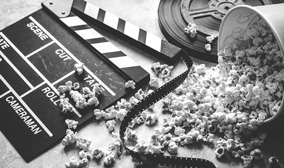 watching movie with popcorn on gray background close up