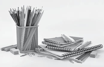 Notebook and copybook stack with metal holder pencils, pens, paper clips, sharpener and eraser on a white background  Back to school concept