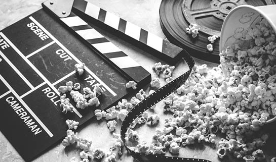 watching movie with popcorn on gray background close up