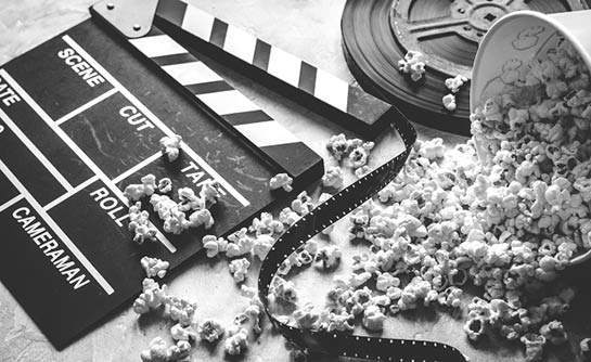 watching movie with popcorn on gray background close up