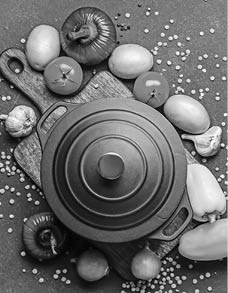 Vegetables and cooking pot on dark background