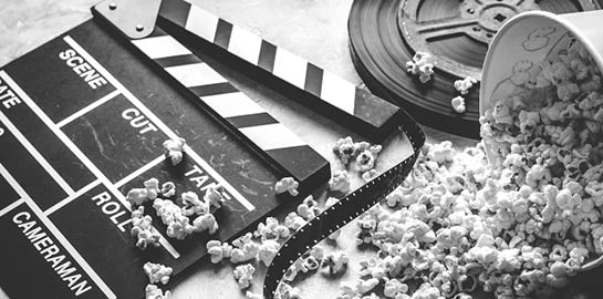 watching movie with popcorn on gray background close up