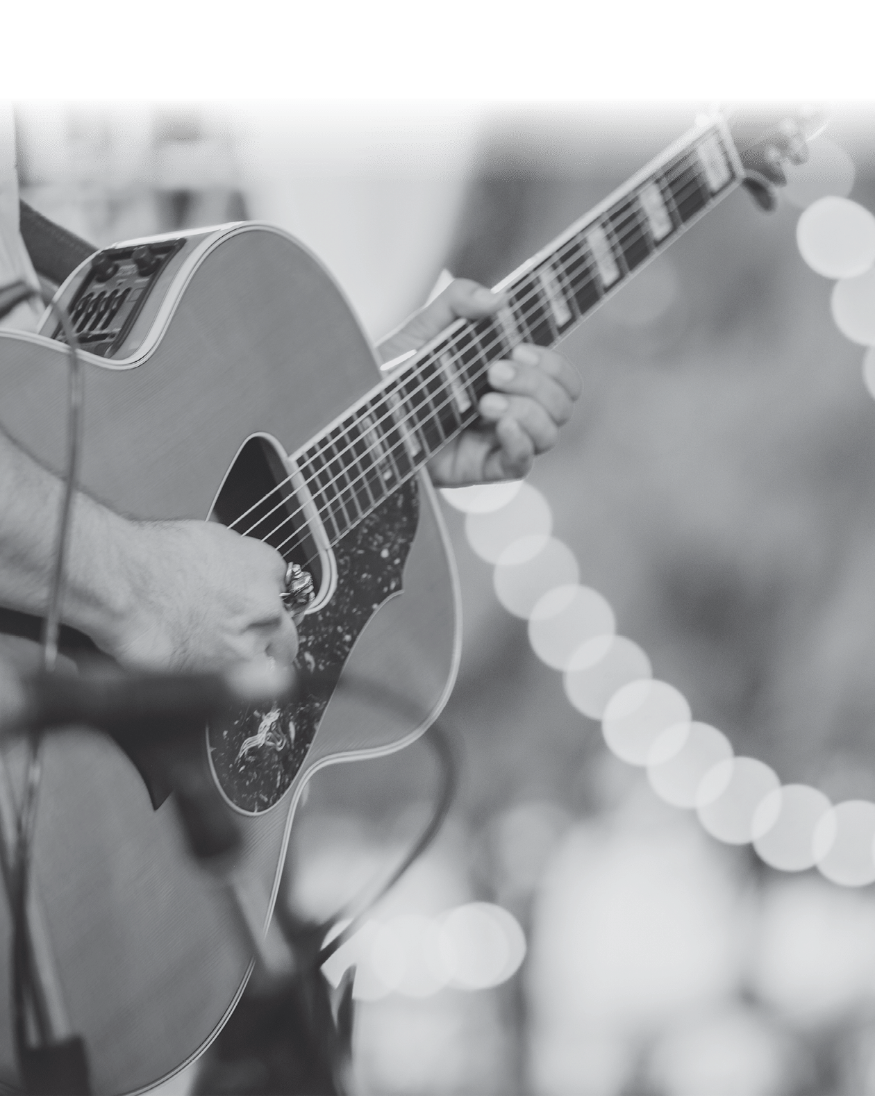 man playing acoustic guitar on stage