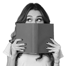 Portrait of a pretty young girl hiding behind an open book and looking away isolated over gray wall background