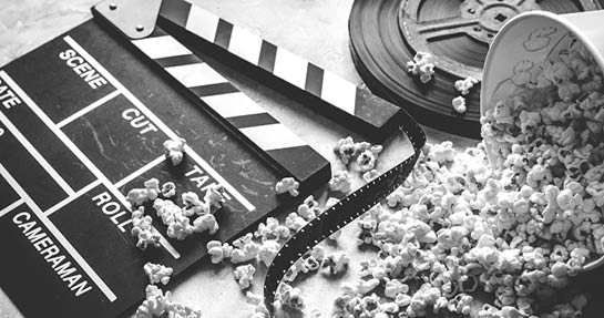 watching movie with popcorn on gray background close up